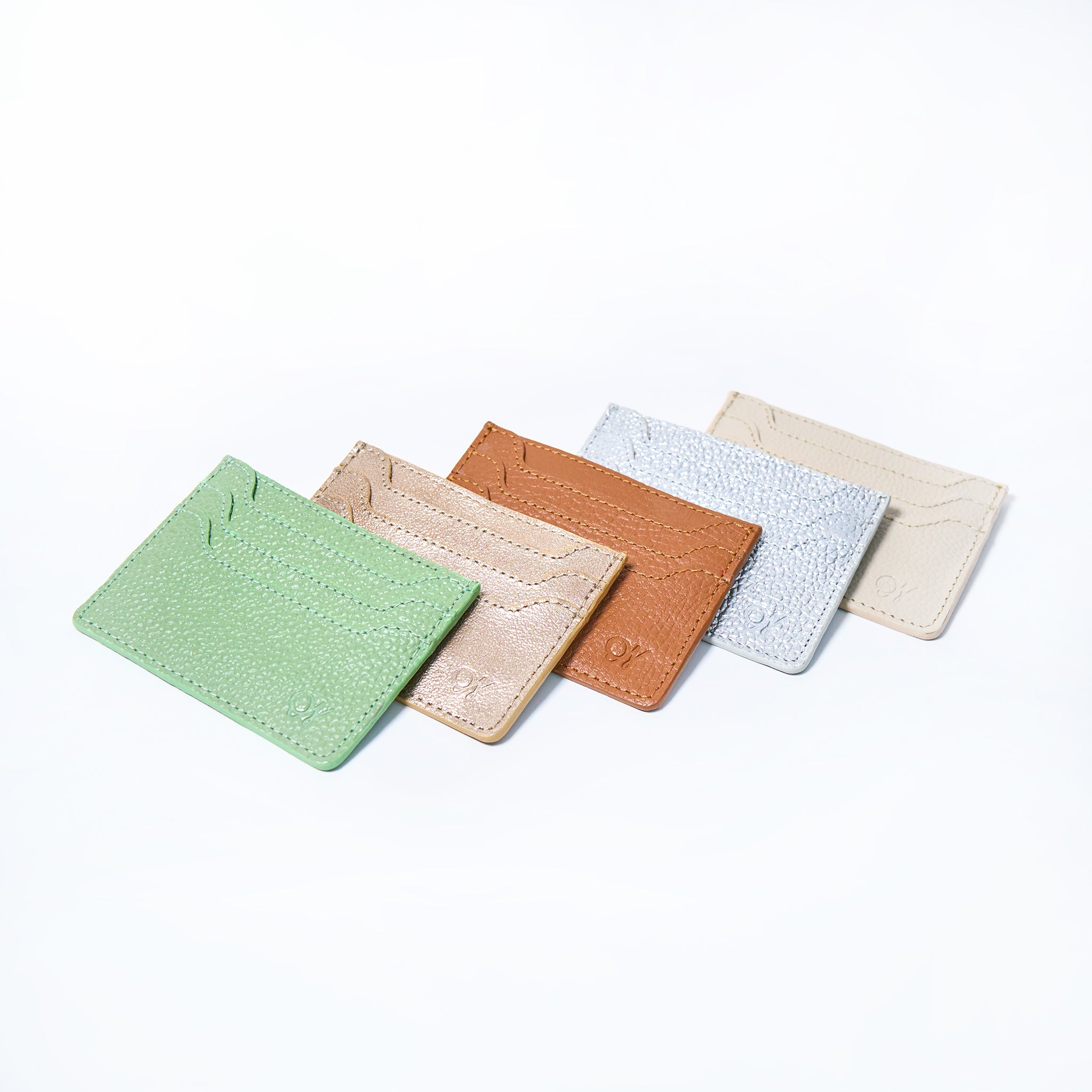 Set of five Celeste slim leather wallet handcrafted by Oda Nova with 6 card slots, sleek and minimalist design in various colors on a white background