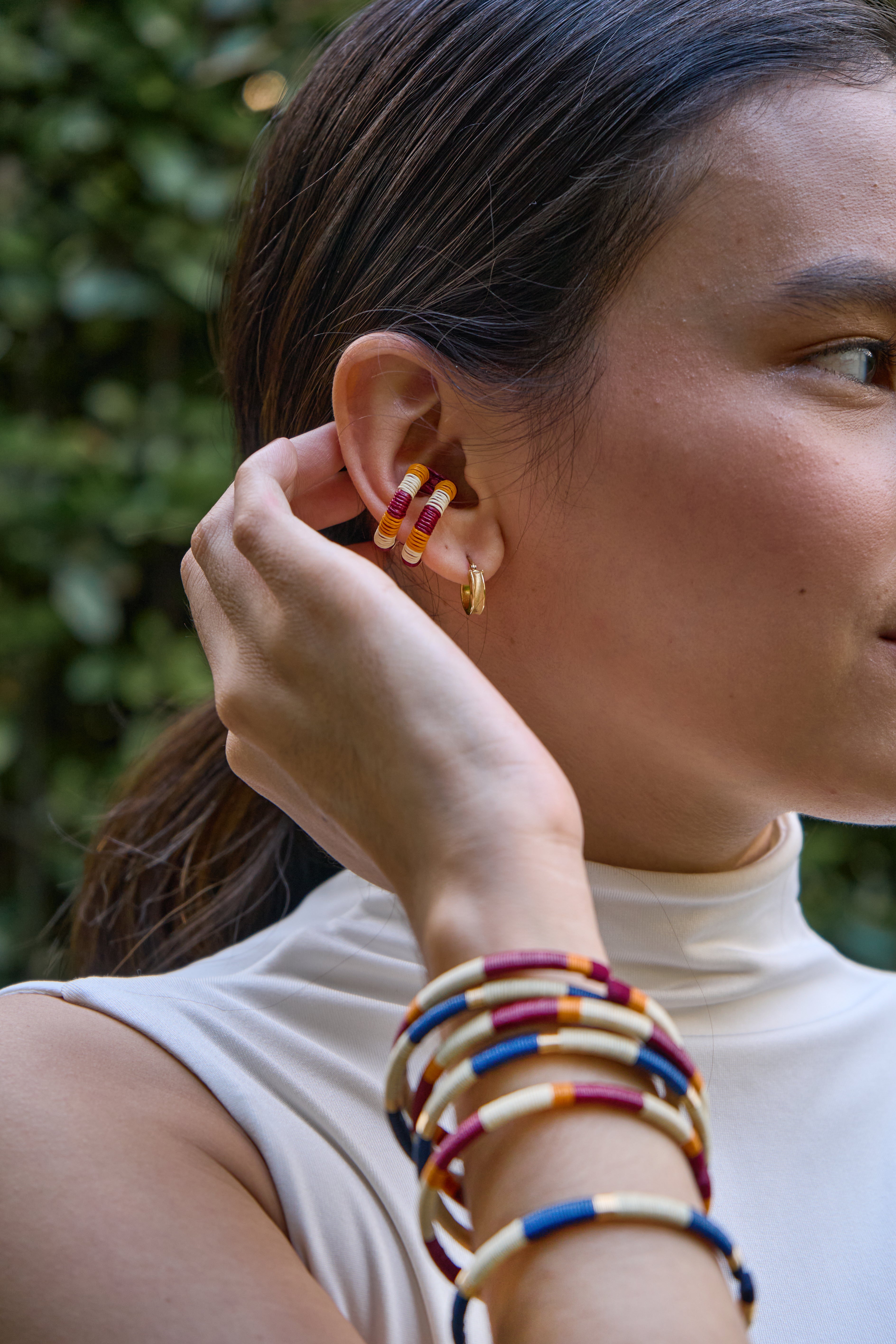 woman wearing colorful handmade earcuff and bracelets